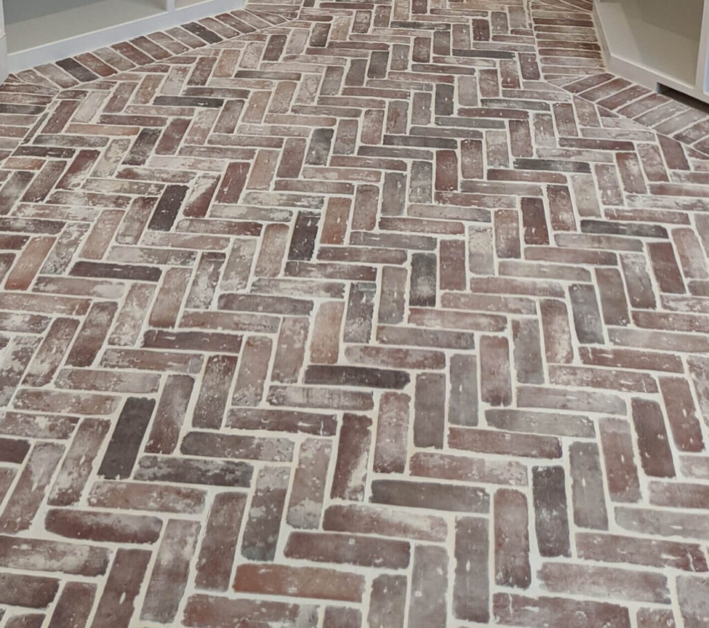 Brick flooring in a herringbone pattern.