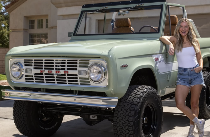 Angela Rose standing next to her restored 1969 bronco.