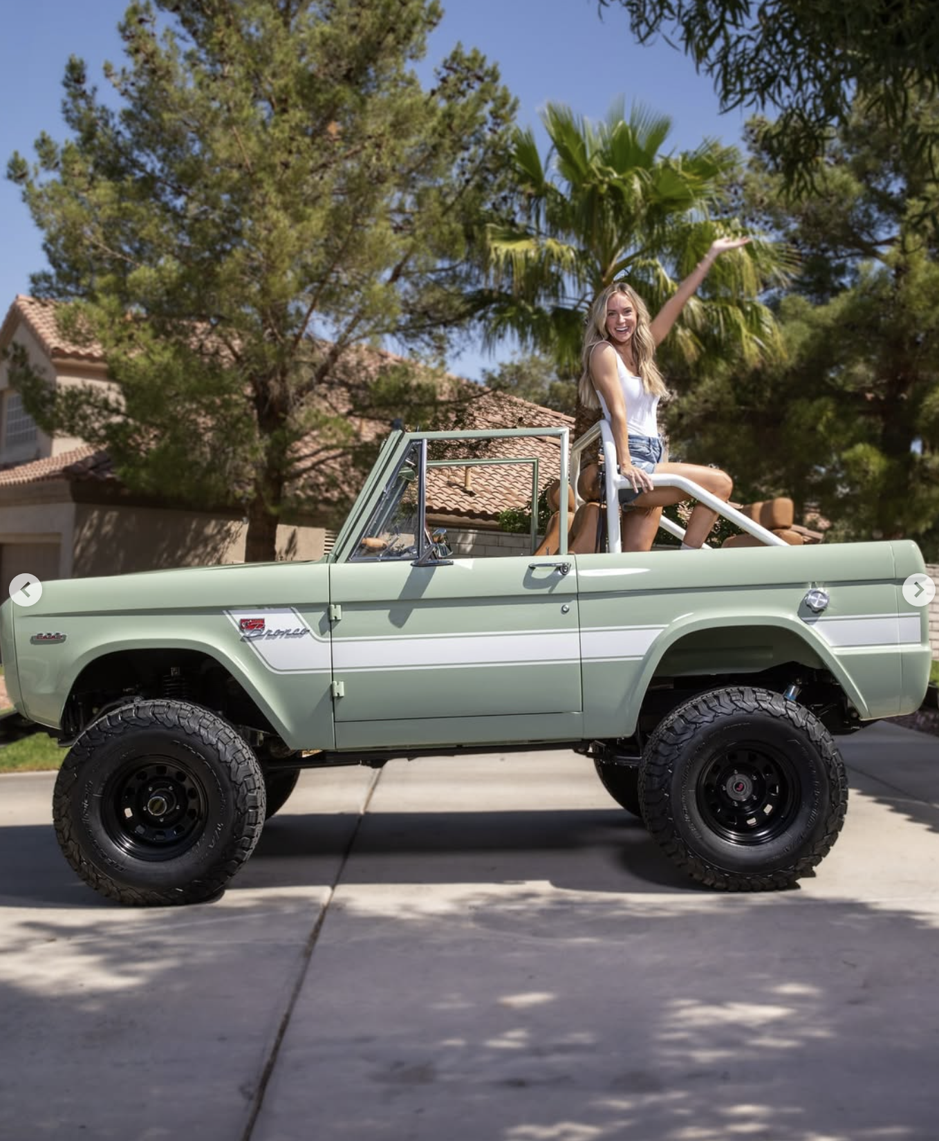 Angela Rose sitting in the back of her 1969 Bronco.