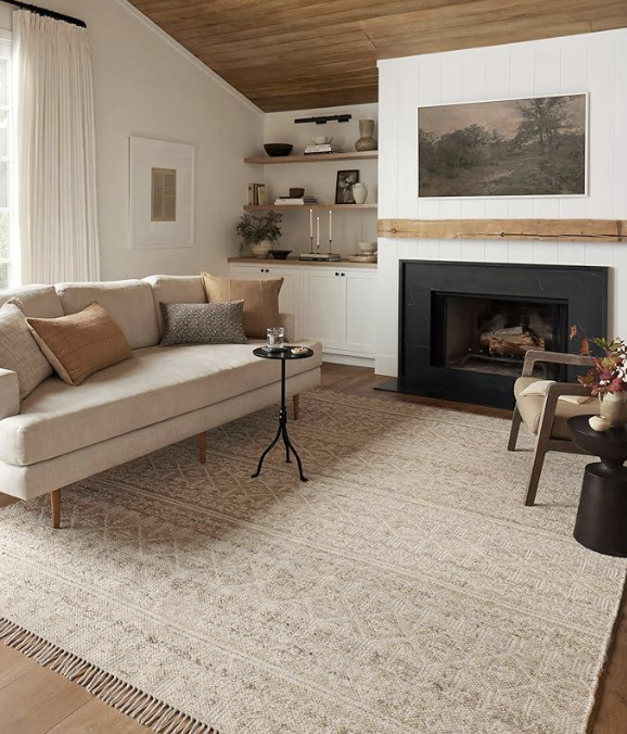 Layered fall home decor with ghost blanket, ivory rug, and plum garland for cozy autumn living.